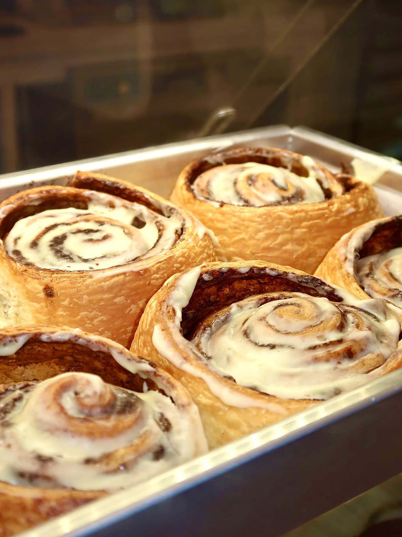 A tray of frosted cinnamon rolls