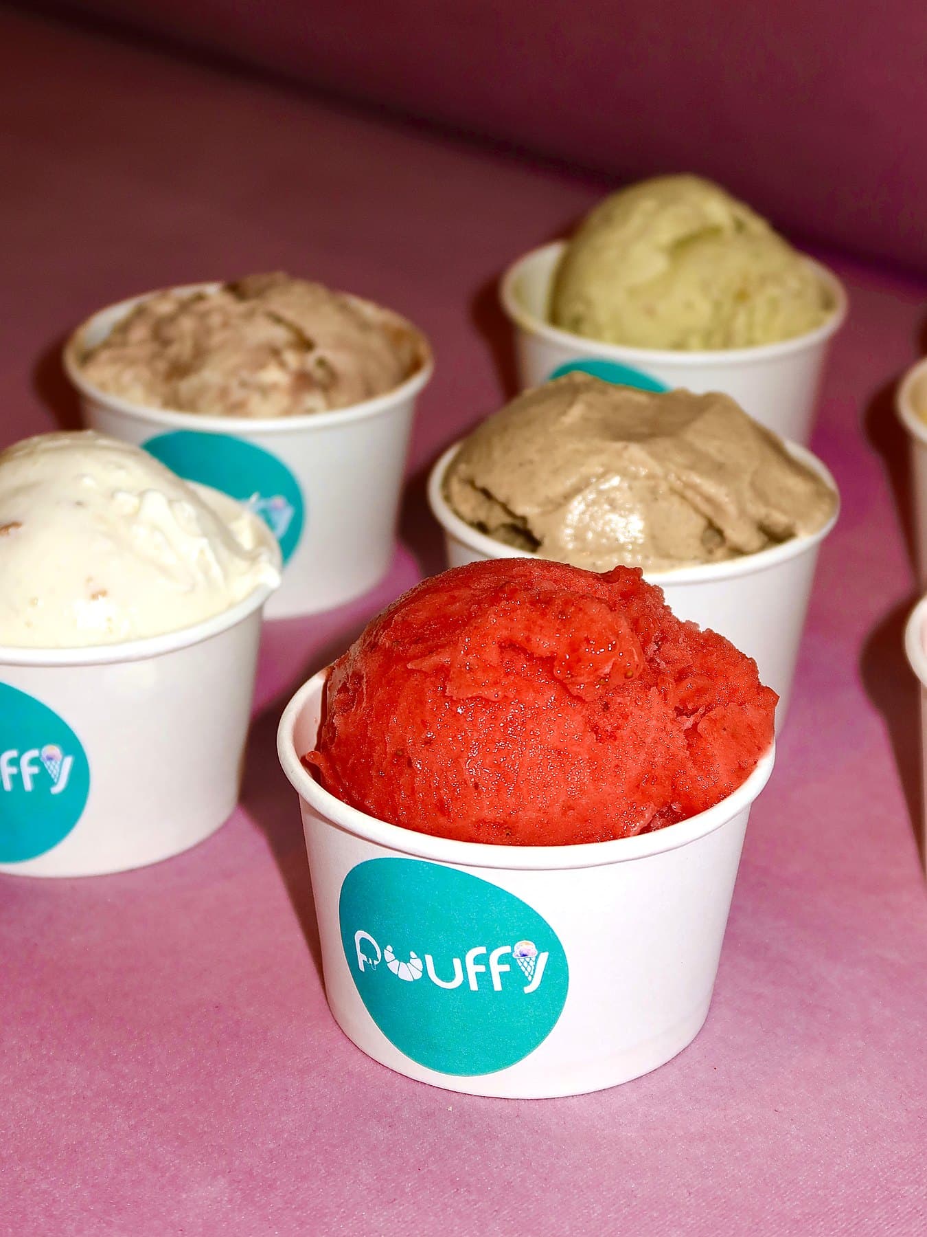 Cups of strawberry sorbet, chocolate and pistachio ice cream in Puuffy cups