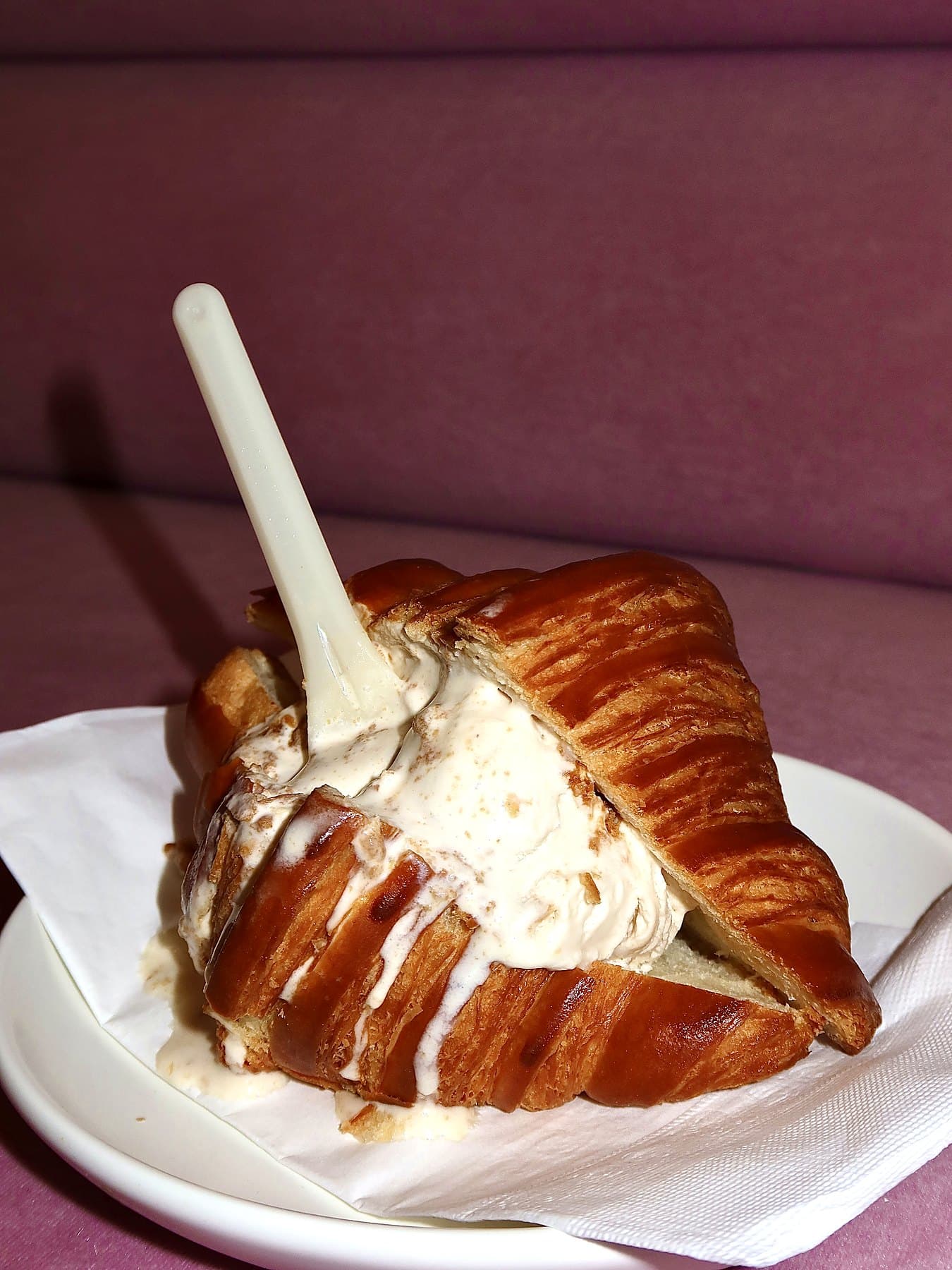 Croissant ice cream sandwich on a plate